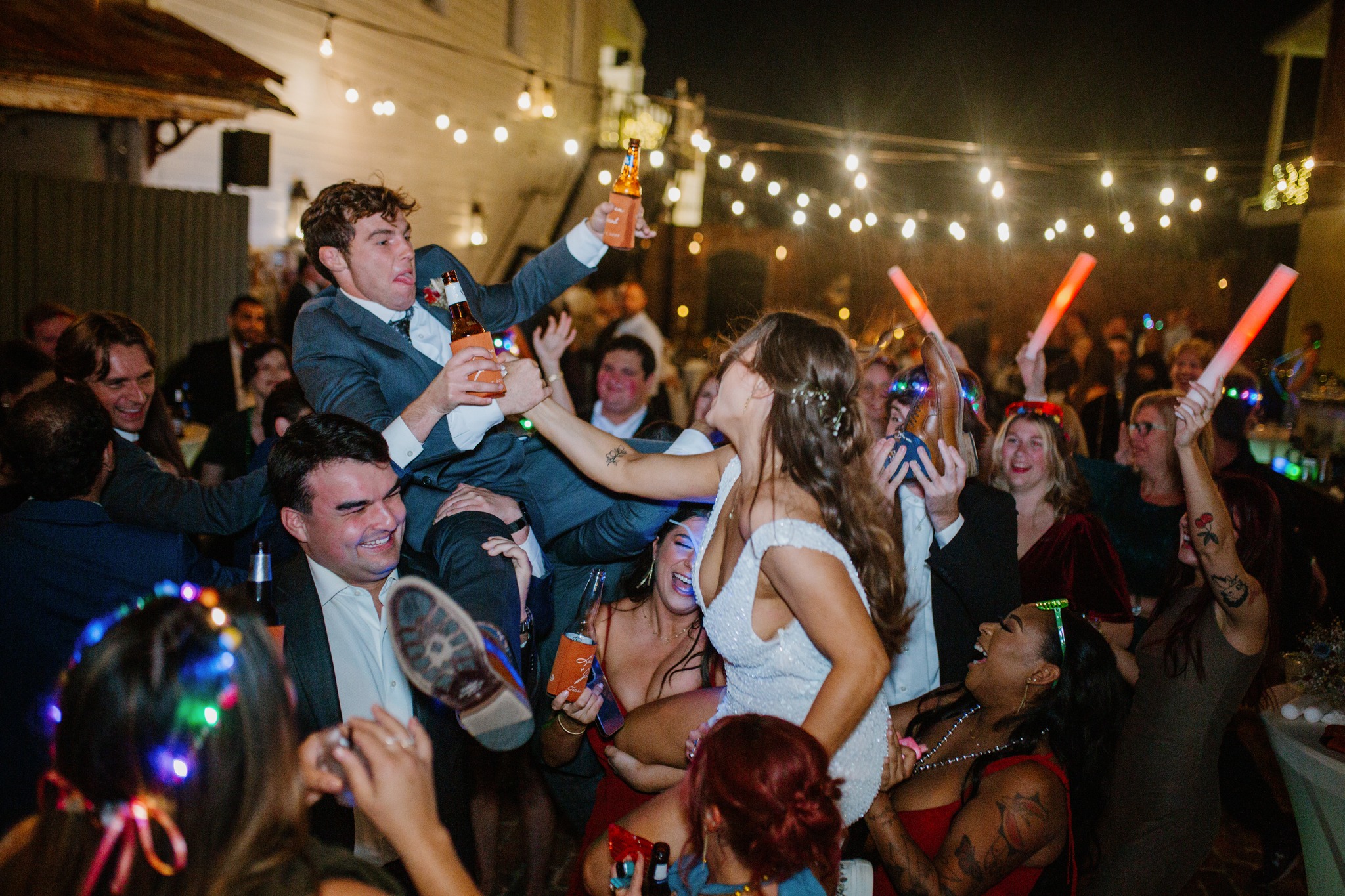 Wedding guests celebrating at Maison De Tours outdoor reception with string lights Saint Martinville Louisiana