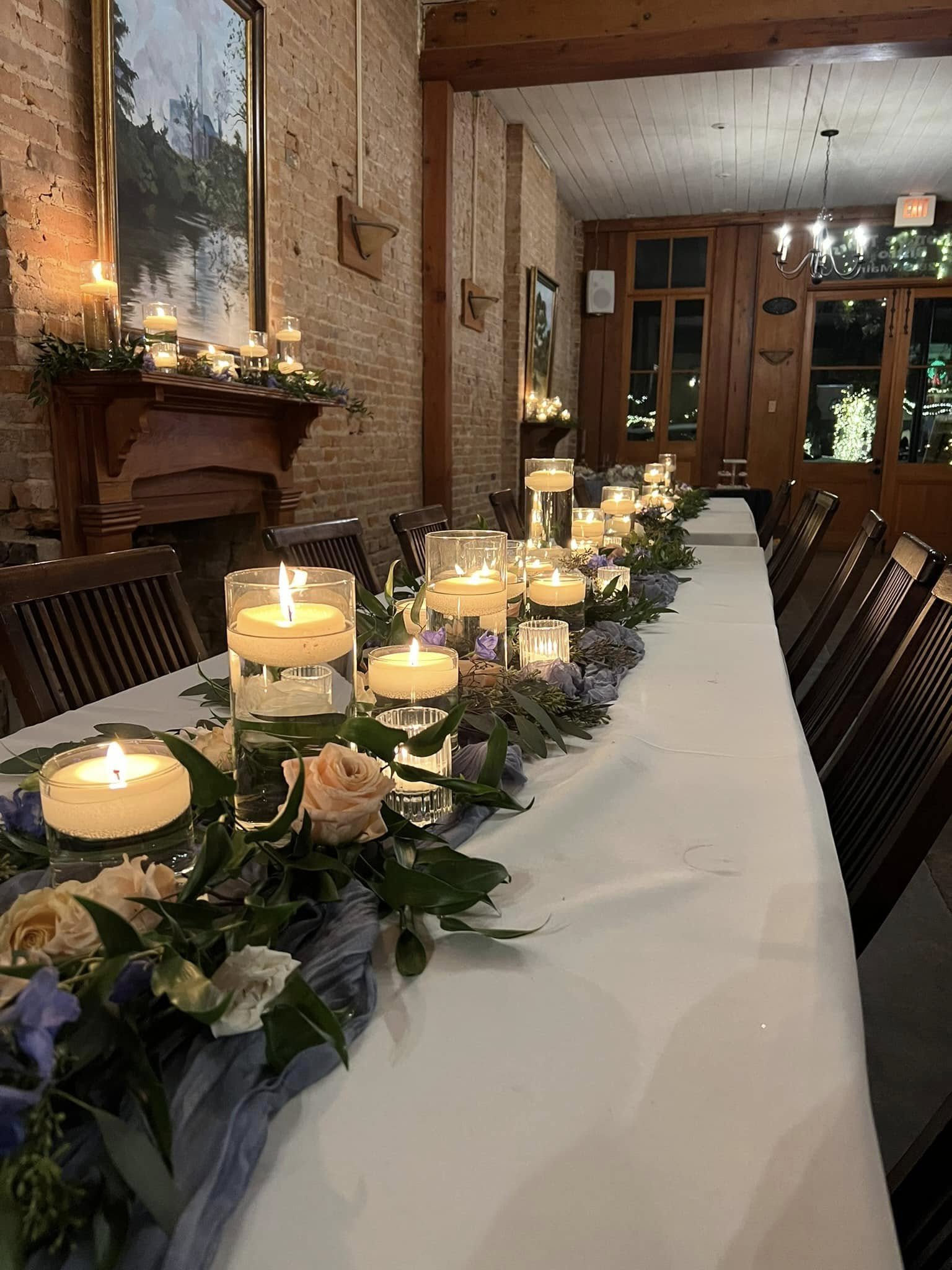 Candlelit reception table with floating candles and florals inside Maison De Tours historic event venue Saint Martinville Louisiana