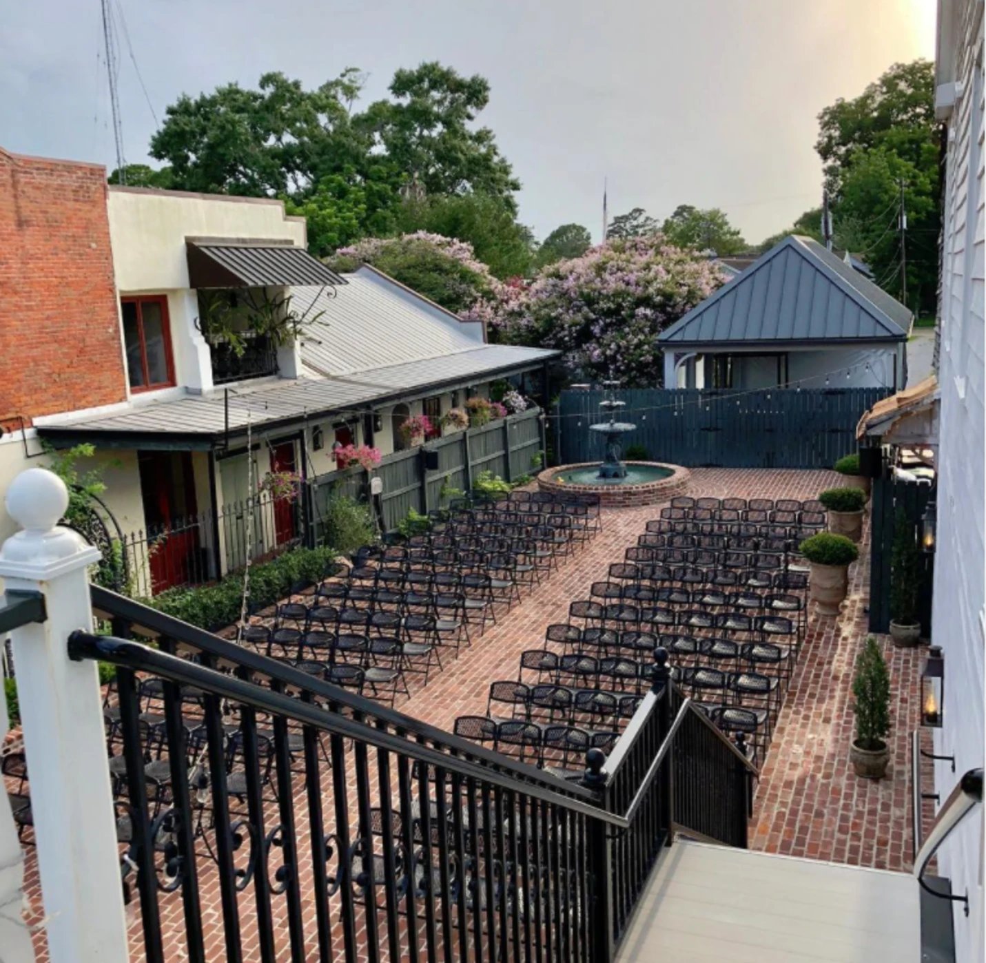 Aerial view of courtyard set for wedding ceremony with fountain at Maison De Tours Saint Martinville Louisiana