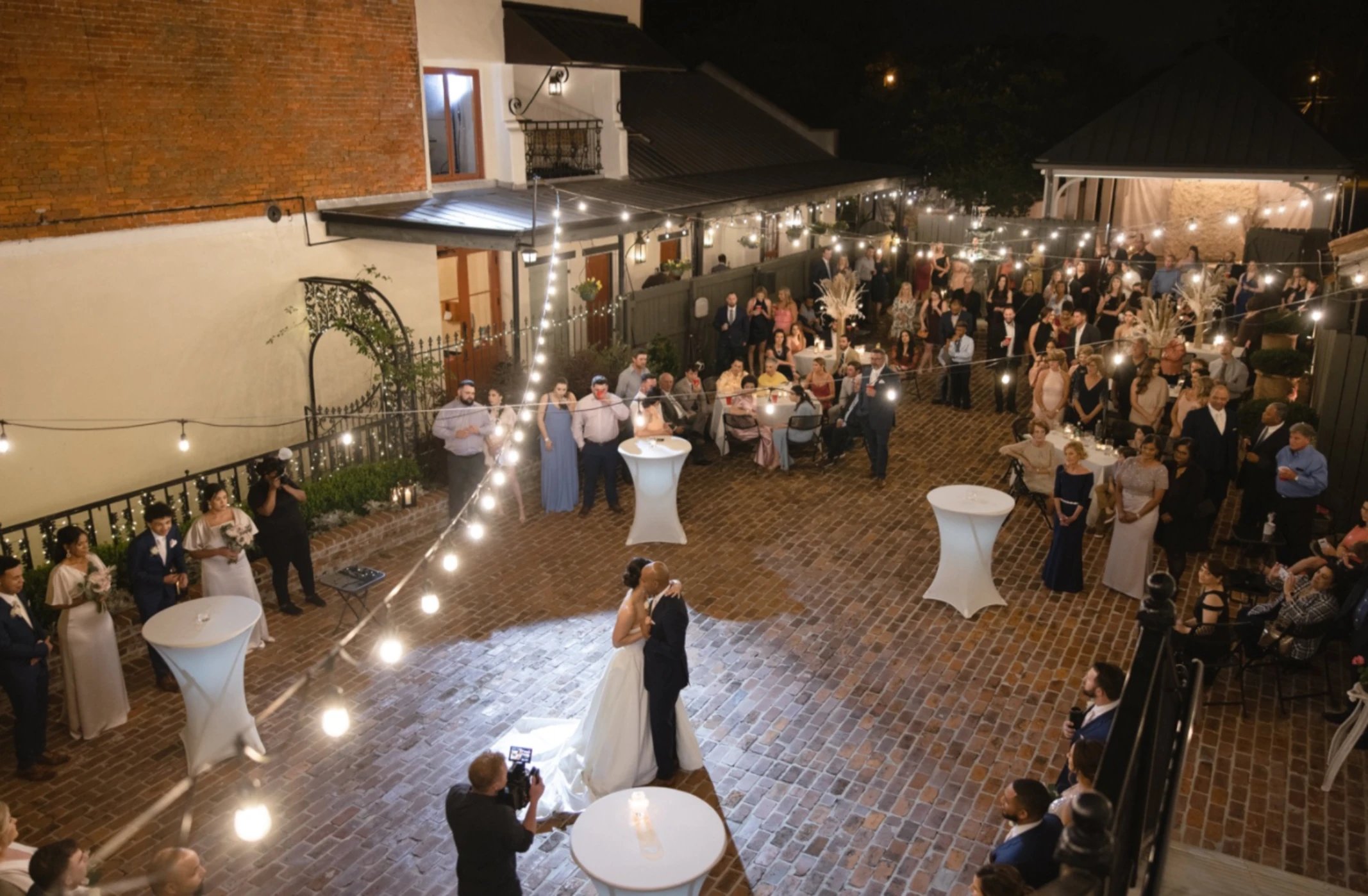 Aerial view of first dance at Maison De Tours wedding reception with string lights and guests Saint Martinville Louisiana