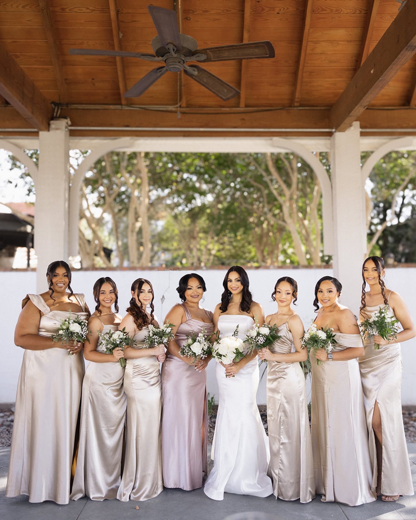 Bridal party in champagne gowns under pavilion at Maison De Tours wedding venue Saint Martinville Louisiana