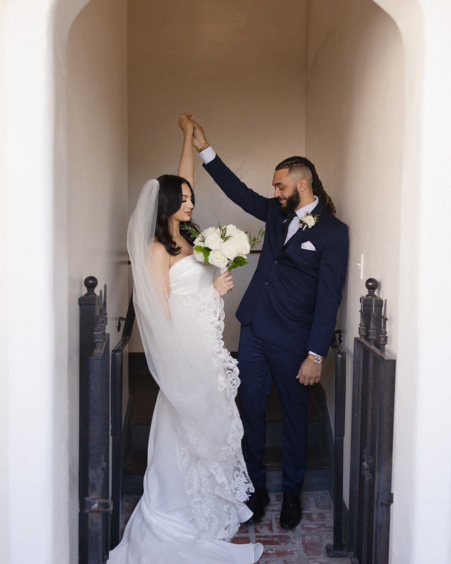 Bride and groom dancing in archway at Maison De Tours historic wedding venue Saint Martinville Louisiana