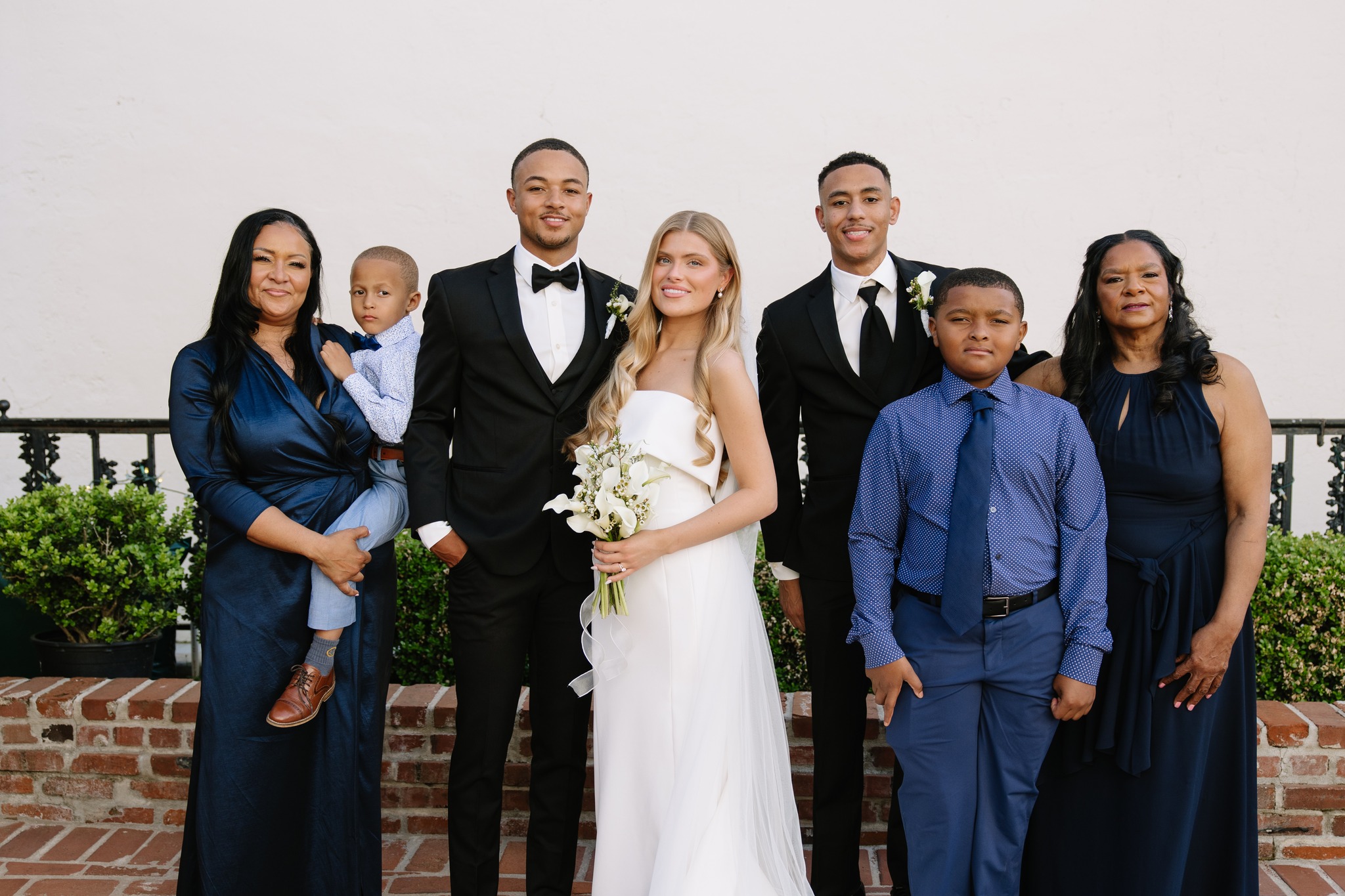 Wedding family portrait on brick courtyard at Maison De Tours historic venue Saint Martinville Louisiana